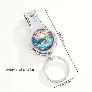 Detail of dragonfly nail clipper keychain with sea turtle art and size measurements
