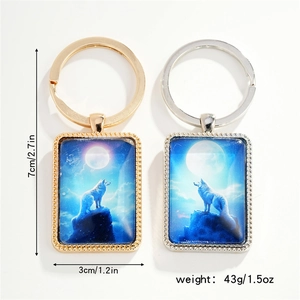 Close-up of rectangle metal keychain showing howling wolf glass dome and size dimensions