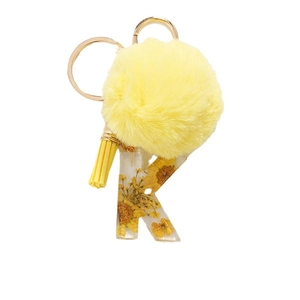 Yellow daisy keychain with pom pom tassel and resin letter K featuring dried flowers