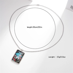 Detail of metal dog tag necklace with wolf art and red white stripes on ball chain