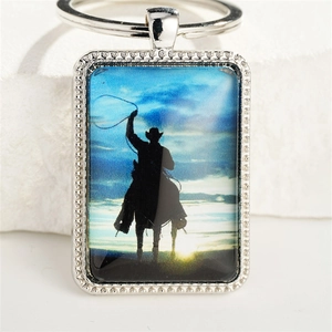 Silver western cowboy silhouette keychain with horse rider and beaded metal frame