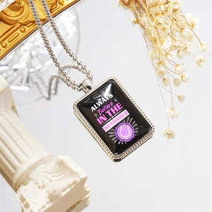 Macro shot of inspirational tennis necklace with purple Always Believe text on black pendant