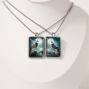 Gothic wolf howling at the moon pendant necklaces on white display bust with bead chains