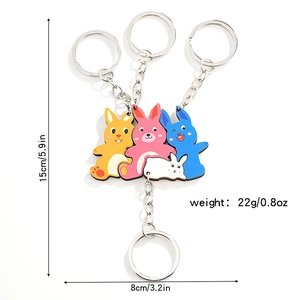 Close-up showing dimensions of colorful cartoon bunny puzzle keychains set for kids