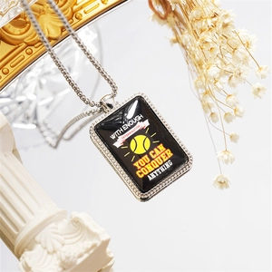 Close-up of tennis pendant with motivational quote on a silver bead chain