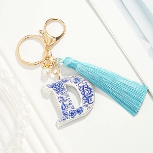Blue floral porcelain letter D keychain with light blue tassel and golden hardware