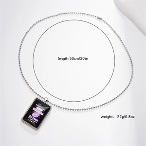 Detail of rugby charm necklace with black enamel finish and polished silver ball chain