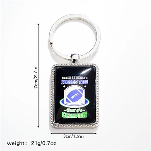 Detail of silver rectangle keychain with football design and Inner Strength quote