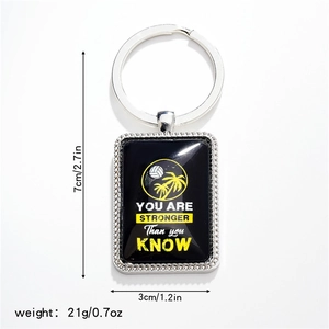 Detail of volleyball metal keychain with inspirational quote and 7x3cm dimensions