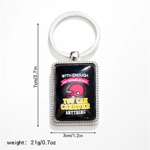 Macro view of rugby helmet metal keychain with inspirational quote and size measurements