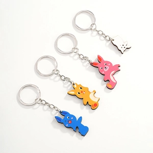 Set of four colorful cartoon rabbit keychains in blue, orange, pink, and white colors