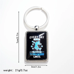 Detail of metal keychain with motivational quote and blue athlete silhouette print