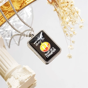Detail of volleyball pendant necklace with inspirational text and silver bead chain