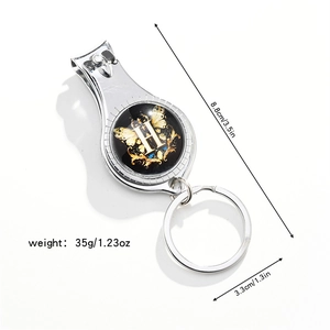 Macro detail of multi-function keychain nail clipper with letter H floral design