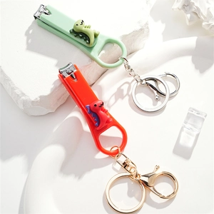 3D cartoon dinosaur nail clippers keychain set in mint green and orange silicone