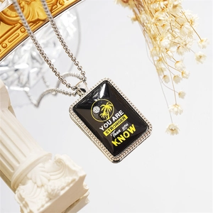 Inspirational metal dog tag necklace with Stronger Than You Know quote and palm tree print