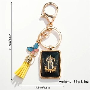 Detailed view of luxury letter B keychain with butterfly charm and tassel dimensions