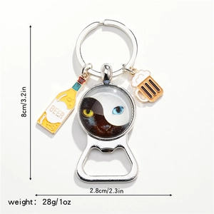 Detail of bottle opener keychain with cat-eye yin yang pattern and beer charms