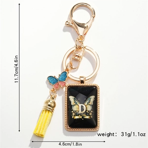 Detail showing dimensions of butterfly keychain with tassel and letter D pendant