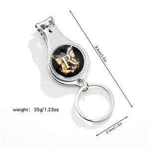 Three-in-one silver keychain with nail clipper, bottle opener, and golden butterfly 'R' motif