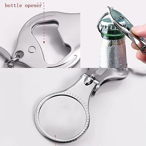 Macro view of portable stainless steel bottle opener keychain with magnifying lens tool