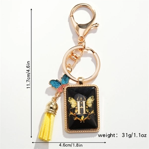 Detailed size specifications for butterfly and letter H keychain with gold tassel