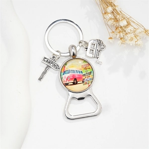 Close-up of camping bottle opener keychain with pink retro camper van glass pendant
