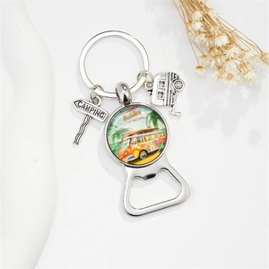 Detail of vintage camper keychain with summer holiday glass dome and camping sign charm