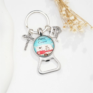 Detail of happy camper metal keychain with retro caravan pendant and glass dome charm