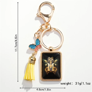 Detail view of M-letter resin keychain with dimensions 11.7cm height and 4.6cm width