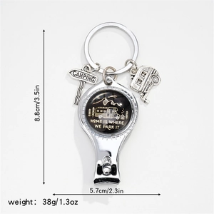 Detail of camping keychain with nail clipper featuring mountains and mini camper charms