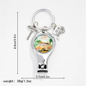 Detail of silver nail clipper with camping charms and vintage surf bus graphics