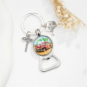 Close-up of vintage camping keychain with wagon glass dome and bottle opener tool