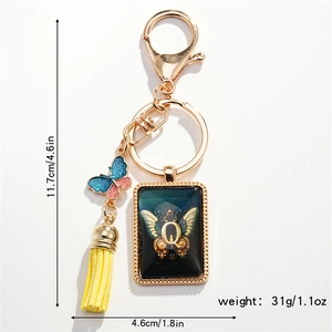 Detailed view of 11.7cm keychain with letter Q pendant, colorful butterfly and yellow tassel