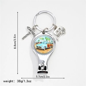 Close-up of camping keychain nail clipper with vintage blue camper van and palm tree design