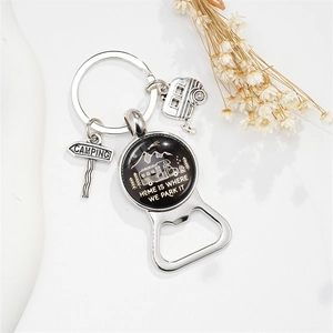Detail of metal camping bottle opener keychain with camper van and road sign charms