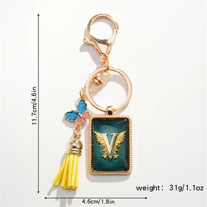 Detail view of American style alphabet V keychain with colorful butterfly and yellow tassel