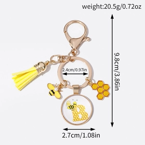 Bee themed keychain with yellow tassel, enamel bee charm and honeycomb acrylic pendant