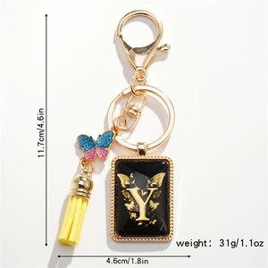 Detail view of letter Y keychain with butterfly pendant, yellow tassel and size markers