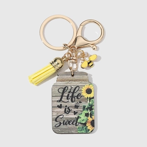 Wooden sunflower keychain with Life is Sweet slogan, yellow tassel, and bee charm