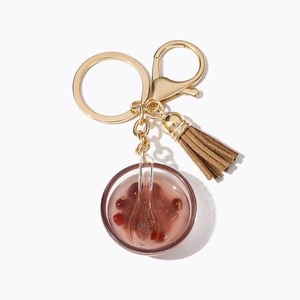 Miniature red bean soup bowl keychain with gold ring and elegant brown suede tassel