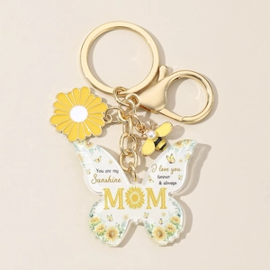 Close-up of yellow butterfly acrylic keychain with Mom text and sunflower details