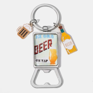Detail of vintage beer bottle opener keychain with mini beer mug and bottle charms