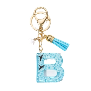 Letter B resin keychain with blue sky, white clouds, bird motifs and tassel pendant