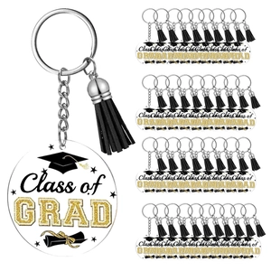 Detail of acrylic graduation keychains with black tassels and GRAD prints in bulk pack