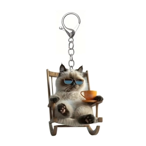 Detail of 2D acrylic keychain featuring a siamese cat in sunglasses on a rocking chair