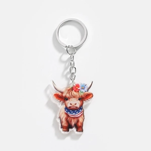 Macro view of highland cow acrylic keychain featuring American flag star-stripe scarf
