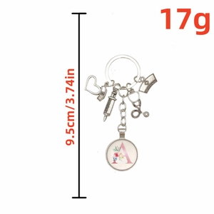 Nurse keychain with syringe, stethoscope charms and floral letter A glass pendant