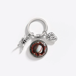 Detail of silver baseball keychain featuring a glass dome charm and bat player pendant