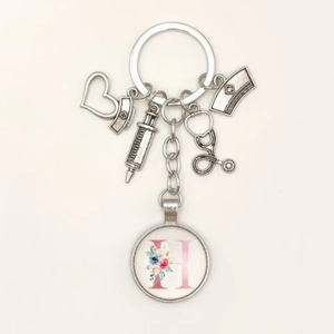 Detail of medical theme keychain with heart syringe stethoscope charms and letter H pendant